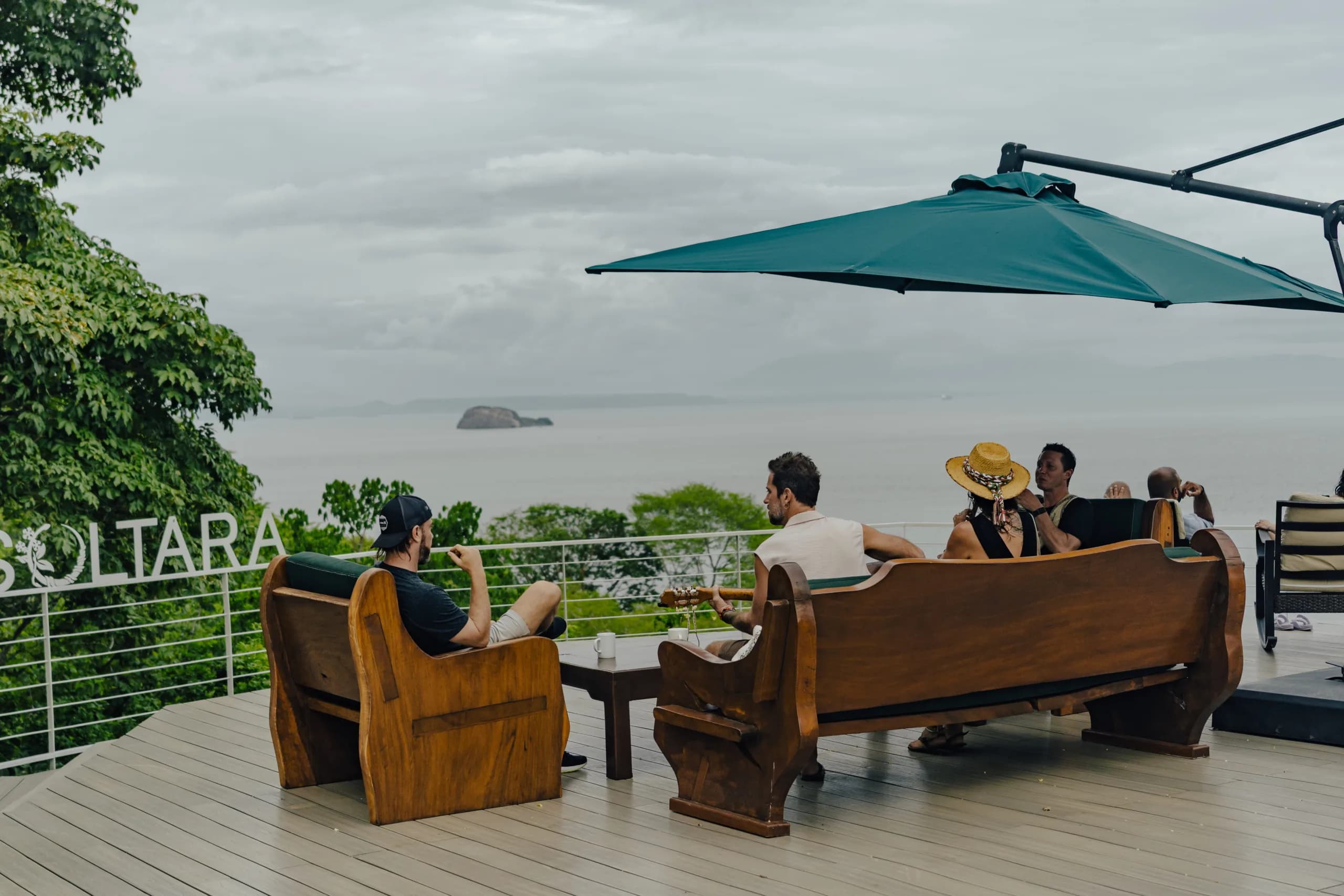 Aerial view of Soltara retreat nestled in lush forest by the sea