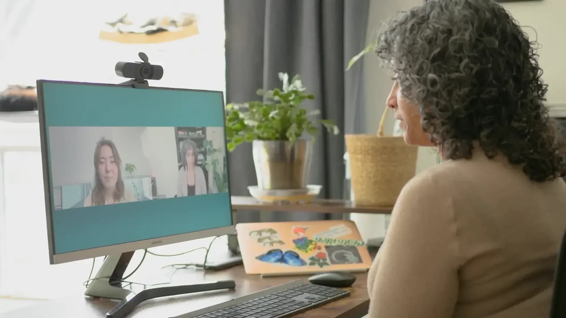 Guest on a video call at a desk during an intake conversation