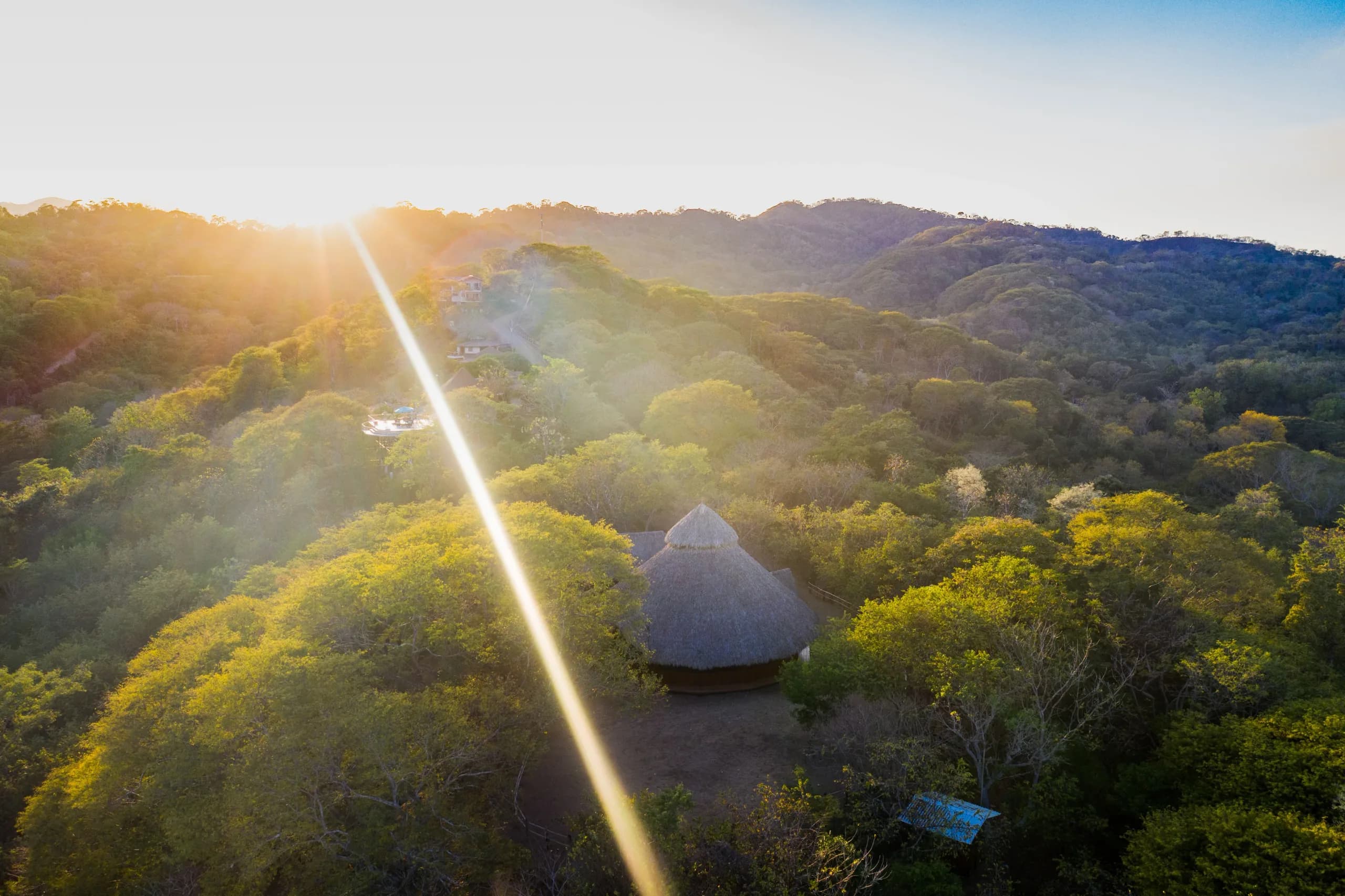 Aerial view of the Soltara sanctuary surrounded by coastline and rainforest