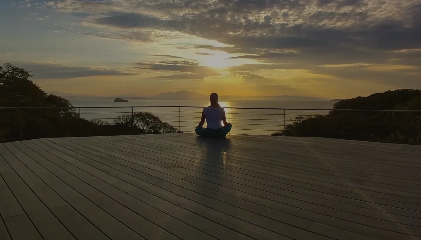 Guest meditating on the Soltara deck at sunset